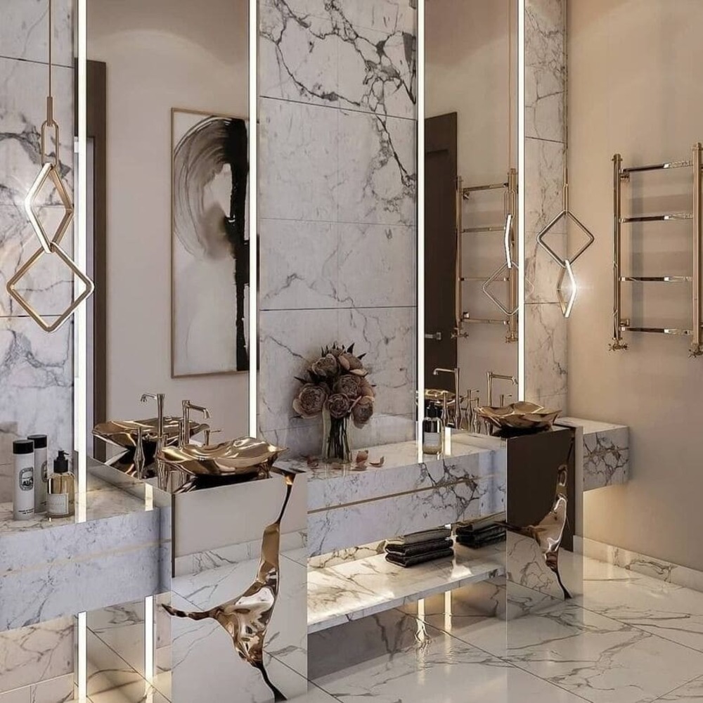 This modern classic washbasin looks perfect in this white marble bathroom. Discover this and other modern classic bathroom design ideas.